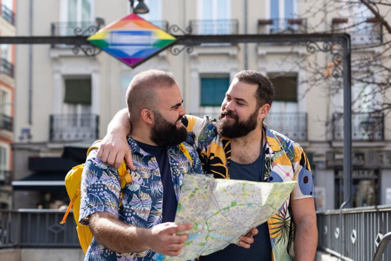 Young,Gay,Couple,With,Tourist,Map,At,The,Exit,Of