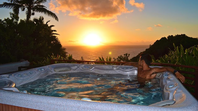 Guest relaxing in an ocean-view hot tub at Hale Akua Retreat Center in Maui