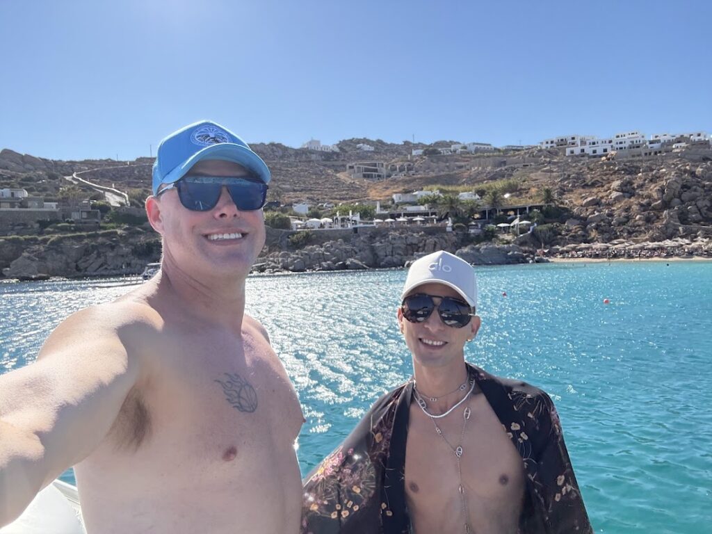 Chris & CK on a yacht in front of Jackie O's Beach Club in Mykonos, Greece.