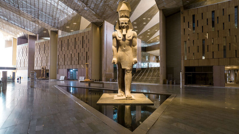 Interior of the Grand Egyptian Museum in Cairo, Egypt, featuring a towering statue of Pharaoh Ramses II — visited on the Pride Adventures Egypt & the Nile LGBTQ+ group trip.