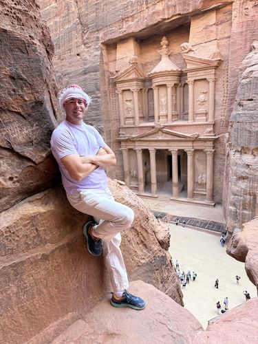 Pride Adventures host Chris Smith at the ancient Treasury in Petra, Jordan, highlighting the optional post-trip extension following the Egypt & the Nile LGBTQ+ group adventure.