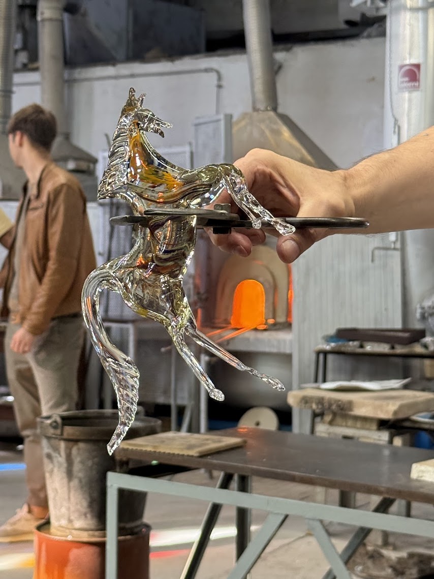 Glass horse sculpture created during a live Murano glass-blowing demonstration in Venice, Italy.