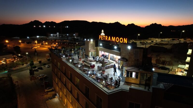Aerial view of the Petra Moon Hotel rooftop at sunset overlooking Wadi Musa Jordan