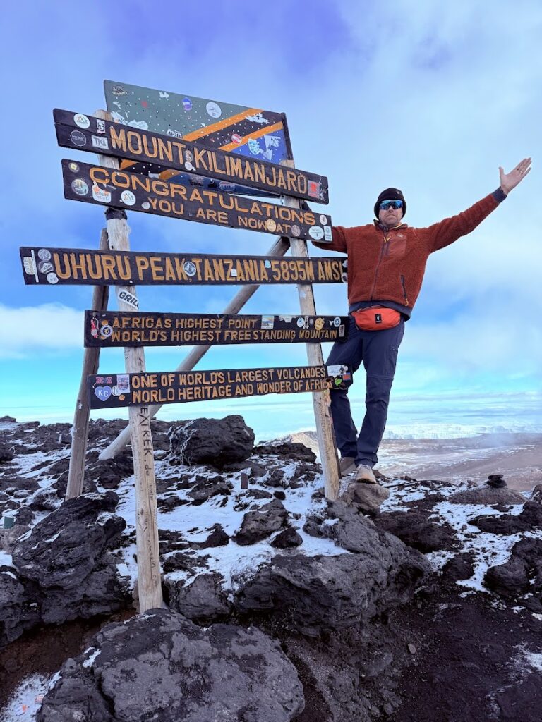 Chris Smith, founder of Pride Adventures at the summit of Kilimanjaro