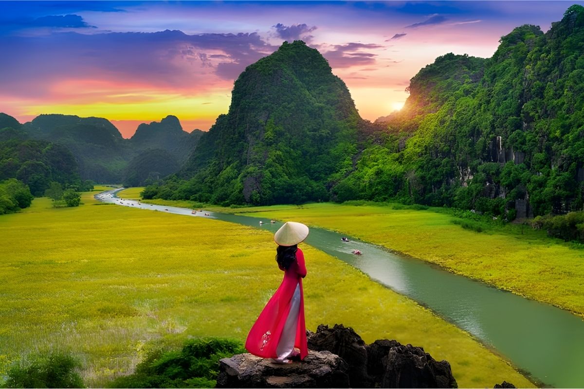 Person overlooking rice terraces in Pu Luong Vietnam at sunset