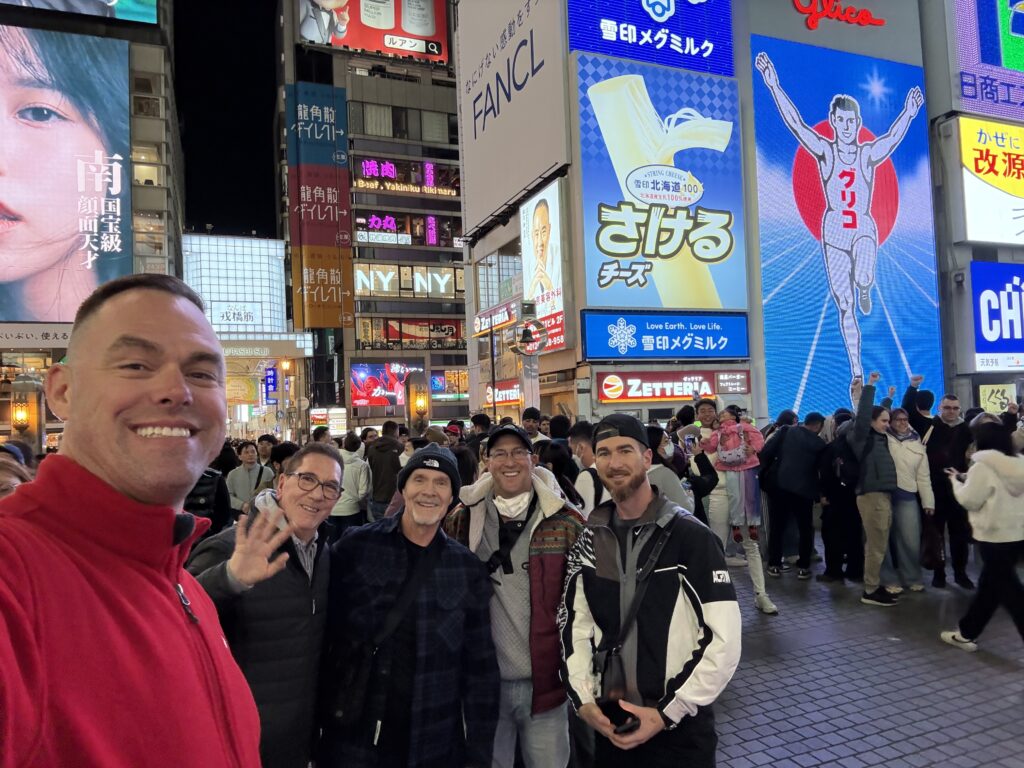LGBTQ+ travel group enjoying the vibrant nightlife of Dotonbori in Osaka Japan