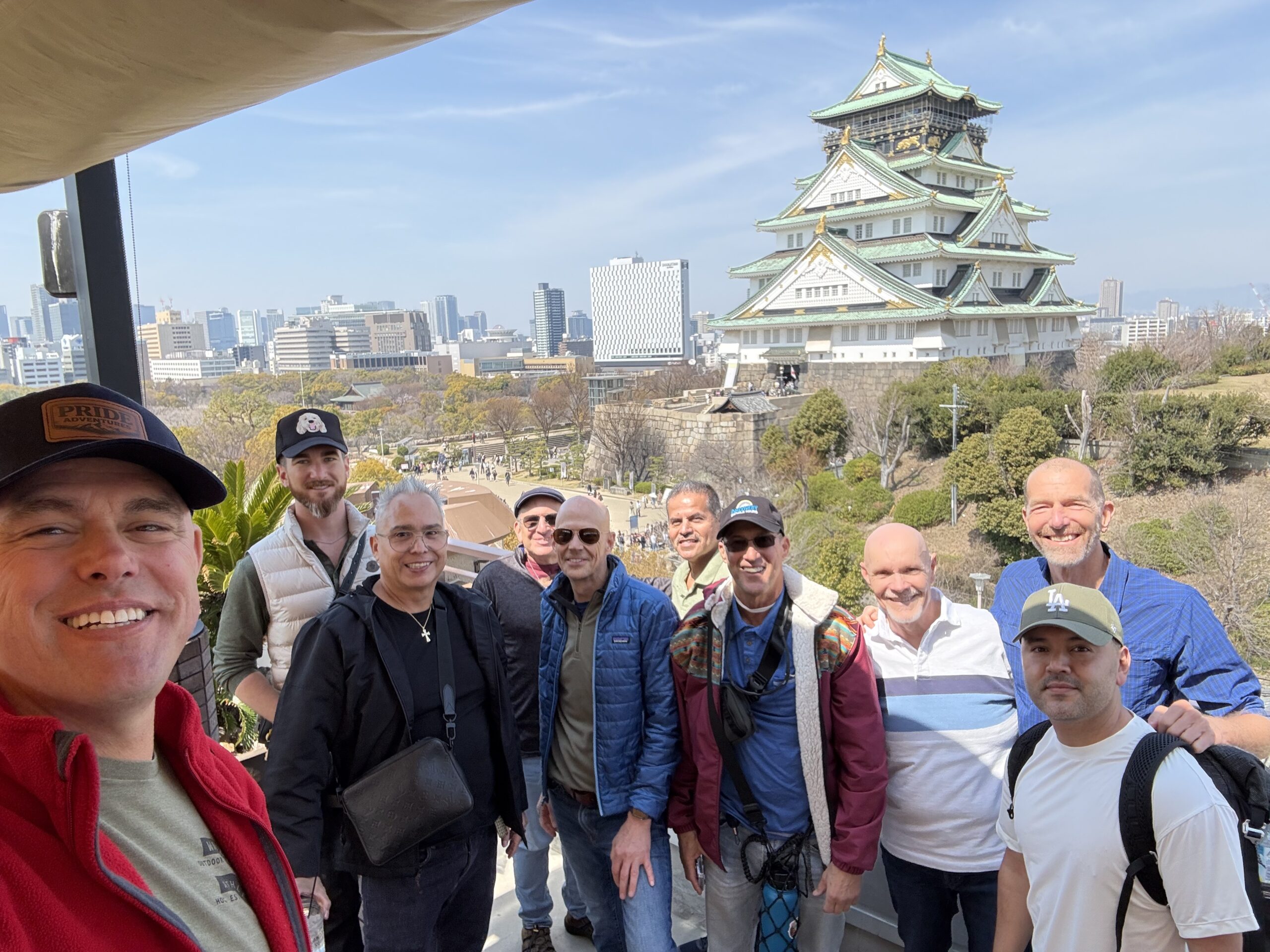 LGBTQ+ travel group selfie at Osaka Castle during a Pride Adventures Japan trip