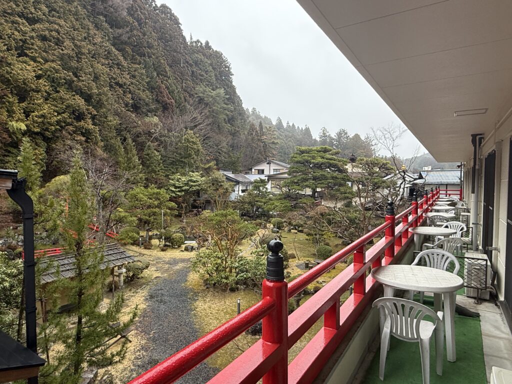 Tranquil Buddhist temple garden in Koyasan Japan surrounded by pine trees and mist