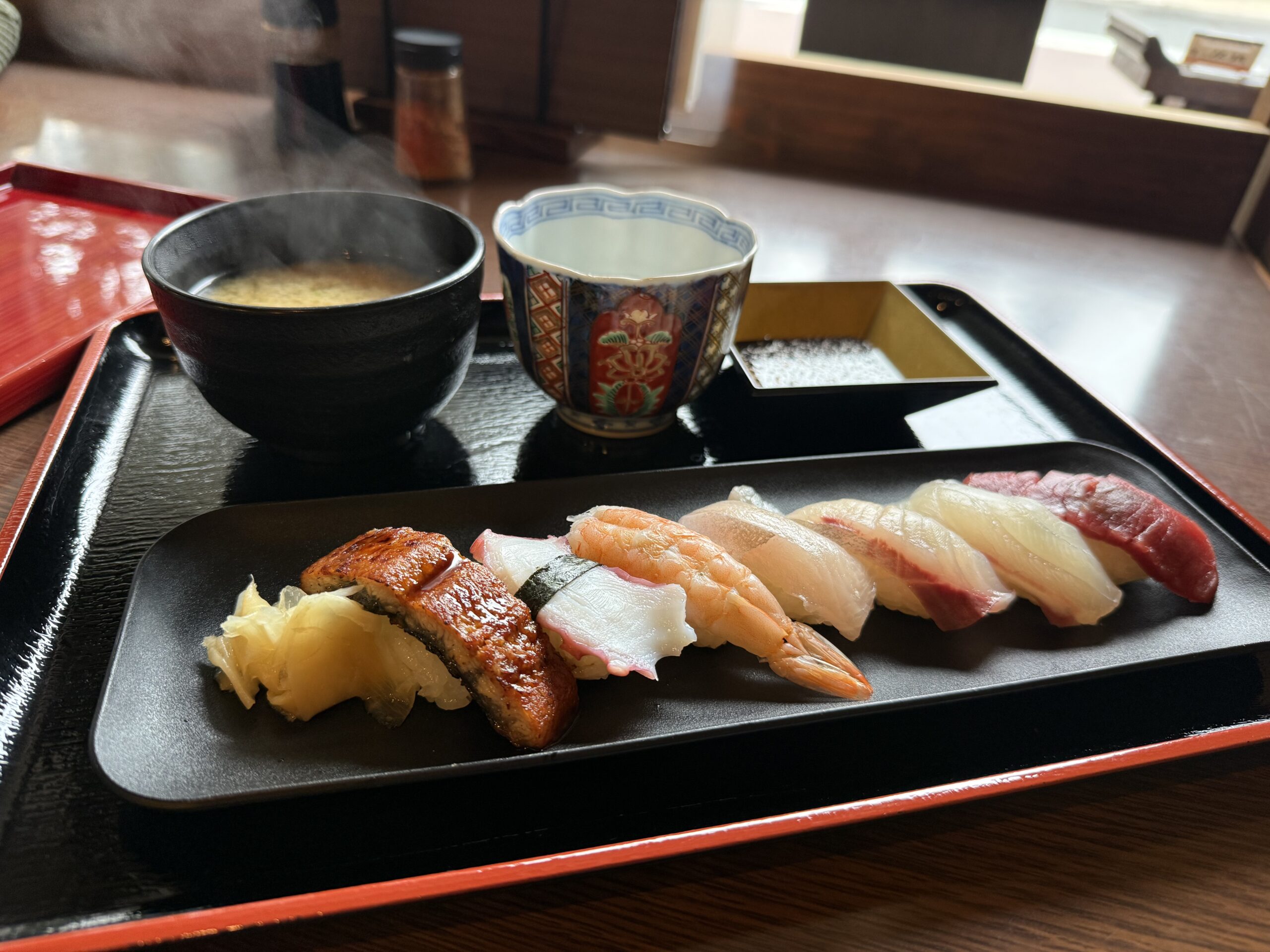 Fresh nigiri sushi platter with sake served at a Japanese restaurant