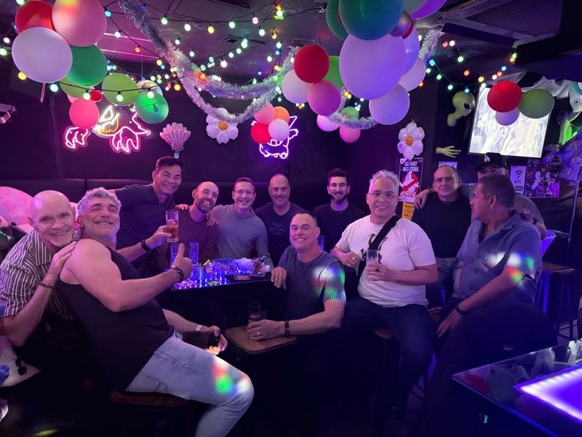 LGBTQ+ group enjoying nightlife at a gay bar in Tokyo Japan with colorful lights