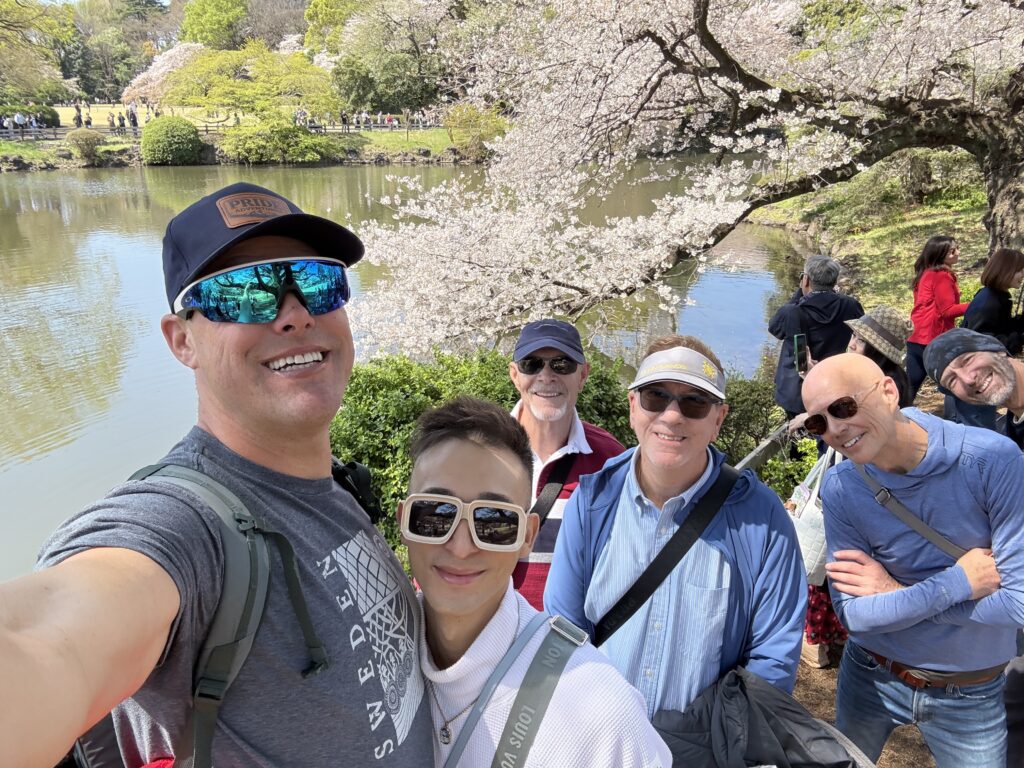 Couple taking a selfie in a Japanese cherry blossom park during an extended stay in Japan