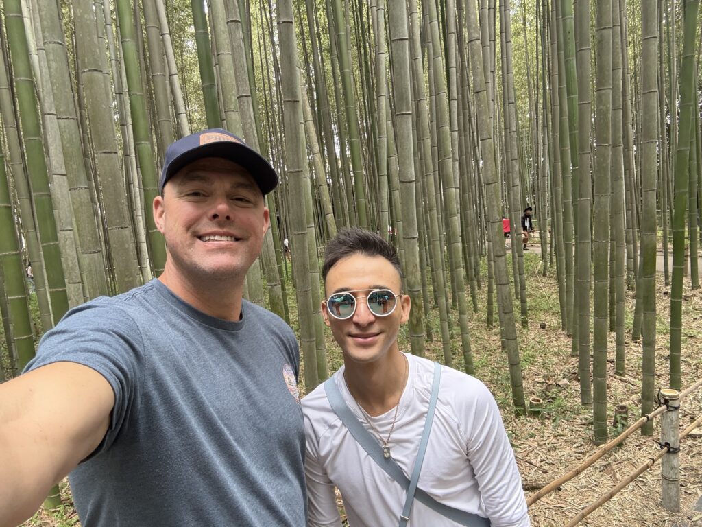 Couple smiling in the Arashiyama bamboo grove in Kyoto Japan on an extended Japan trip