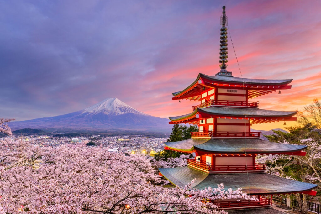 Chureito Pagoda with Mount Fuji and cherry blossoms at sunset in Japan