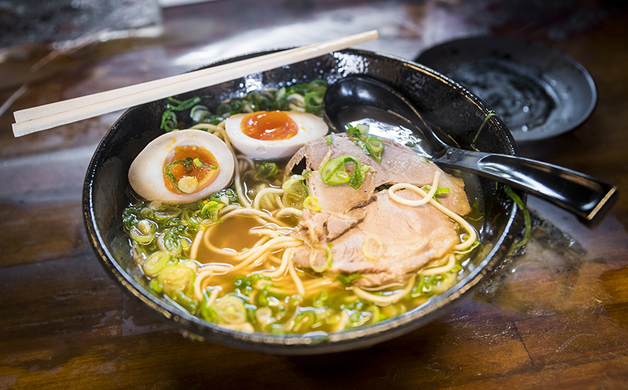 Traditional Kyoto ramen bowl with soft boiled egg and tender pork in Japan