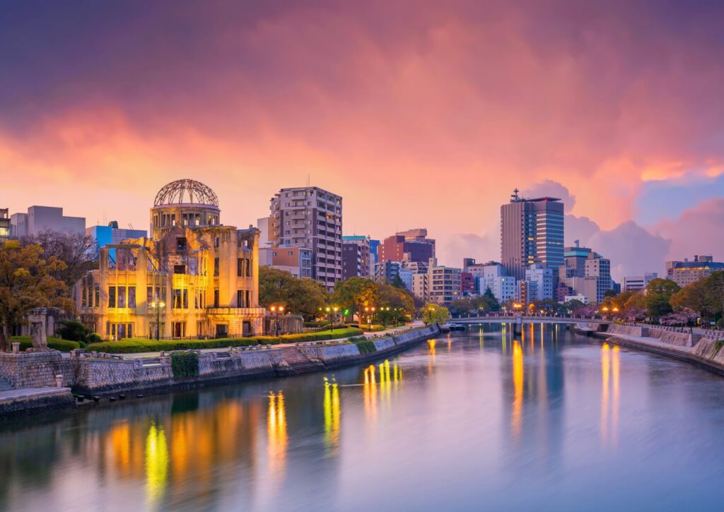 Hiroshima Atomic Bomb Dome lit up at dusk reflected in the Motoyasu River Japan