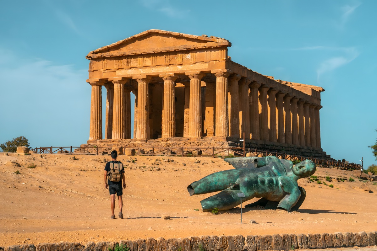 Visitor standing before the ancient Temple of Concordia at Valley of the Temples Agrigento Sicily on Pride Adventures LGBTQ+ tour