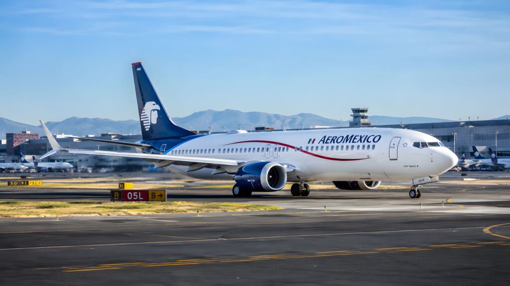 Aeromexico Boeing 737 aircraft on the tarmac at Mexico City International Airport with mountains visible in the distance