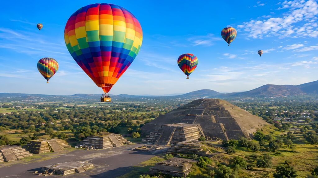 Colorful hot air balloons floating above the Pyramid of the Sun at Teotihuacan near Mexico City at sunrise
