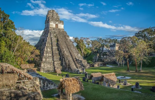 The towering Temple I pyramid at Tikal's Gran Plaza surrounded by jungle and ancient Maya structures, Guatemala