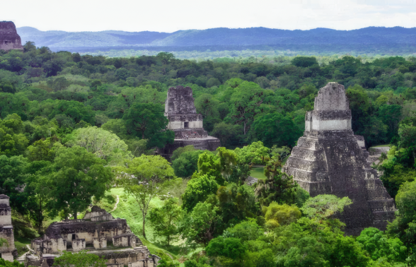 Ancient Maya ruins at Tikal National Park in Guatemala with towering temples rising above the jungle