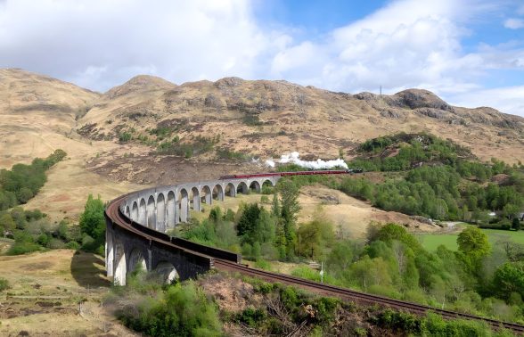Scenic train passing through Glencoe in the Scottish Highlands on the Pride Adventures Scotland LGBTQ+ trip